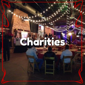 Charity event with people seated at round tables facing a stage with the word charities overlaid on the image.